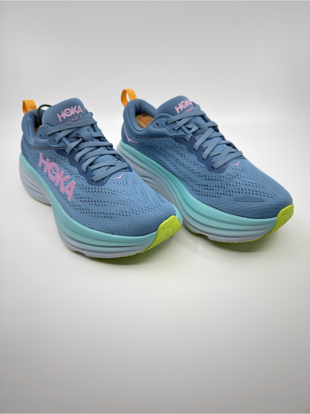 Hoka Women's Bondi 8 Shadow/Dusk blue colorway with pink and lime green details.